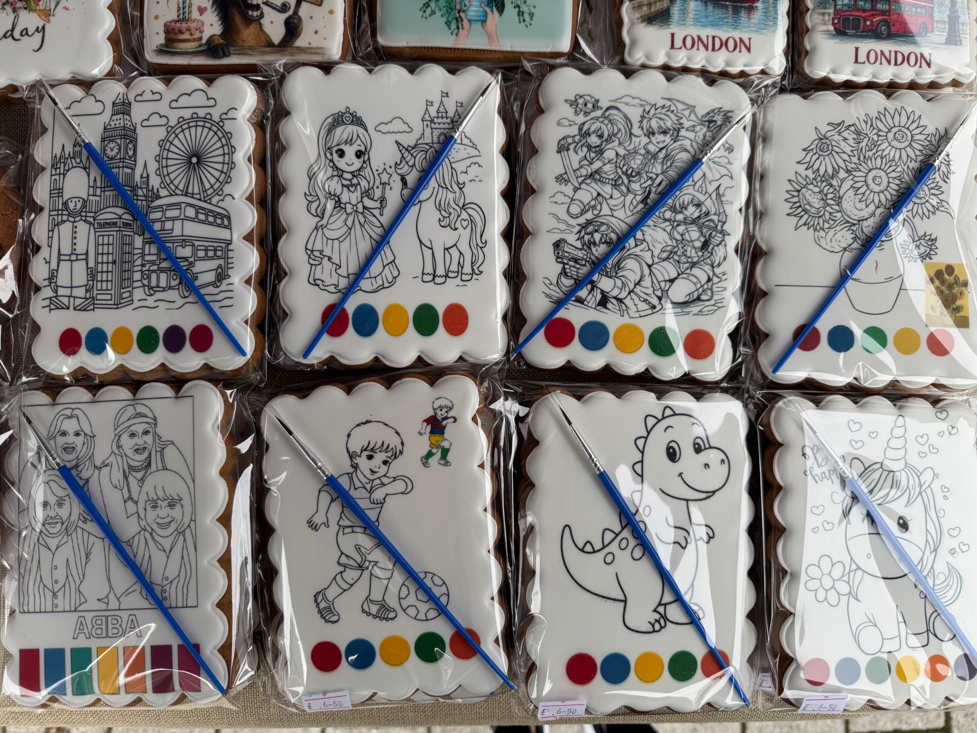 A colourful selection of individually wrapped colour-your-own biscuits with paintbrushes